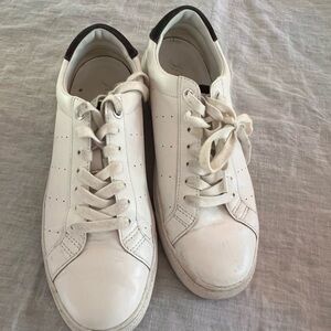 White leather J. Crew sneakers with dark gray detail on the heel.
